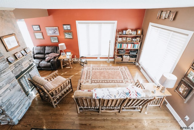 living area with baseboards and wood finished floors