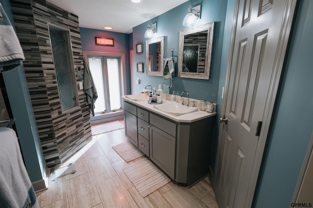 full bath with a sink and double vanity