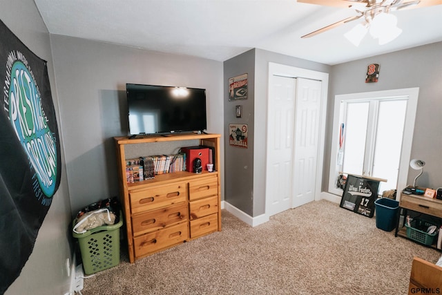 interior space featuring ceiling fan, baseboards, and carpet flooring