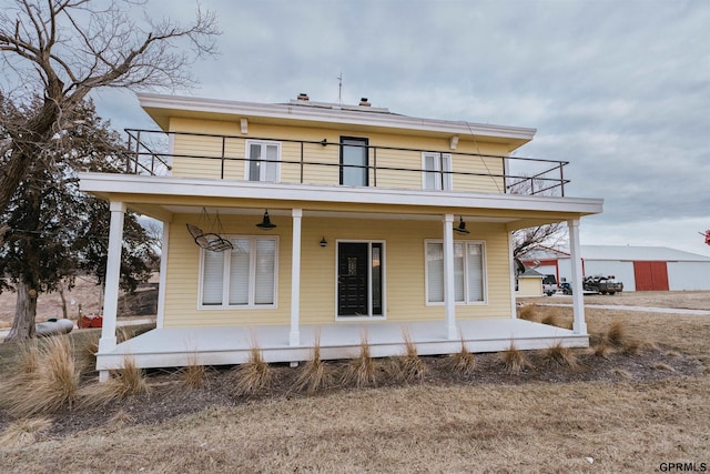 back of property featuring a balcony