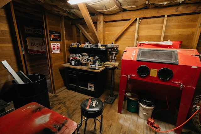 interior space with hardwood / wood-style flooring and wooden walls