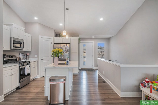 kitchen featuring appliances with stainless steel finishes, white cabinets, and dark wood finished floors