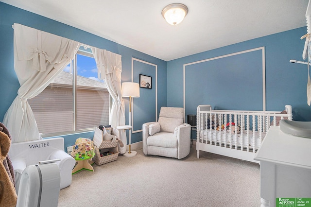 carpeted bedroom featuring a crib