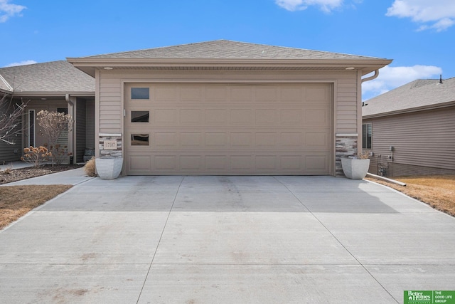 garage featuring concrete driveway