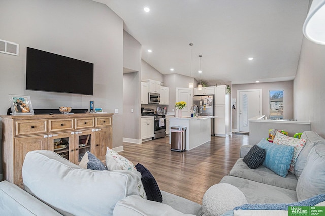 living room with lofted ceiling, dark wood-style floors, visible vents, and recessed lighting