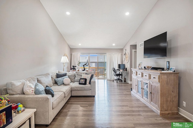 living room featuring visible vents, baseboards, light wood-type flooring, high vaulted ceiling, and recessed lighting