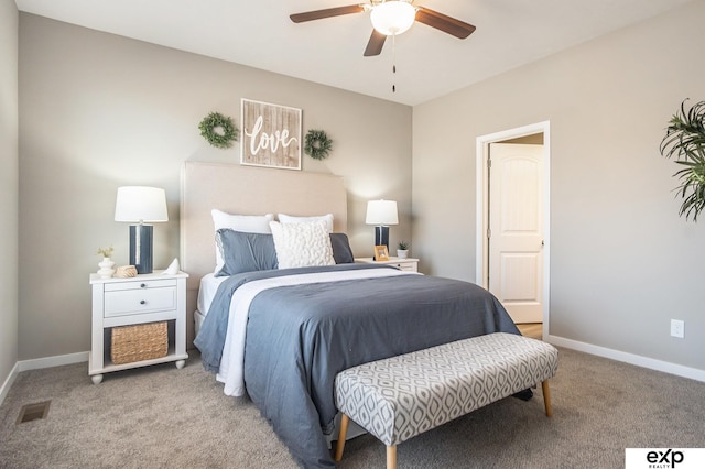 bedroom featuring light colored carpet, ceiling fan, visible vents, and baseboards