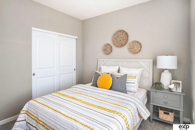 carpeted bedroom with a closet and baseboards