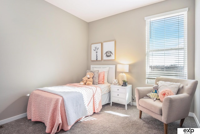 bedroom with carpet floors and baseboards