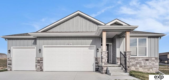 view of front facade with stone siding, concrete driveway, board and batten siding, and an attached garage