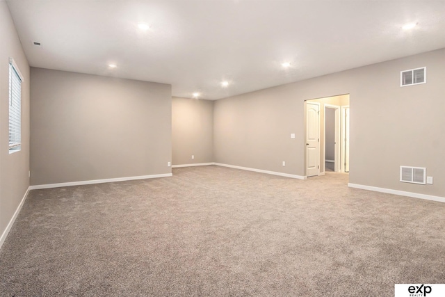 spare room featuring baseboards, visible vents, carpet flooring, and recessed lighting