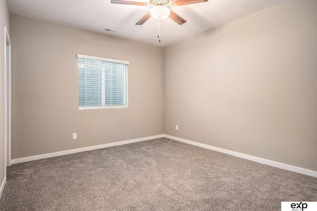 unfurnished room with ceiling fan, carpet floors, visible vents, and baseboards