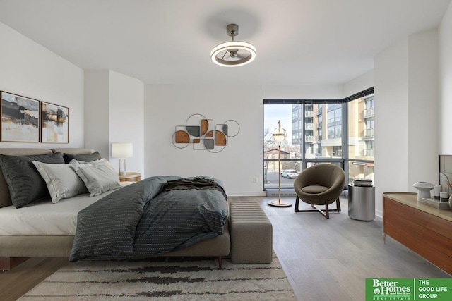 bedroom with baseboards and wood finished floors