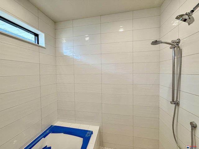 full bath featuring tiled shower