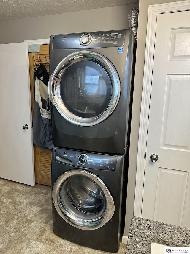 washroom featuring laundry area and stacked washer / dryer