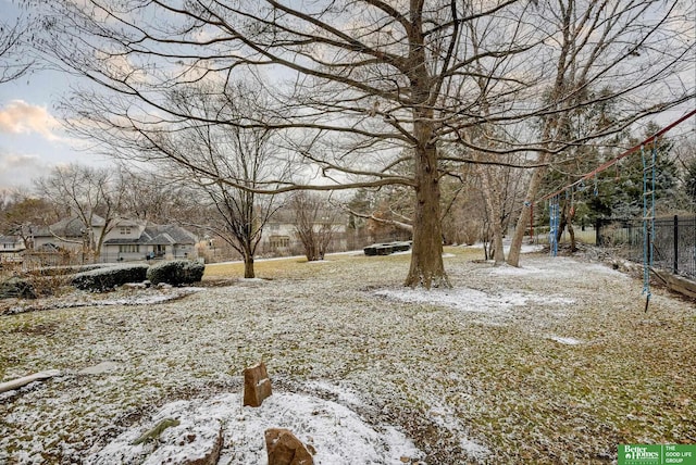 snowy yard featuring fence