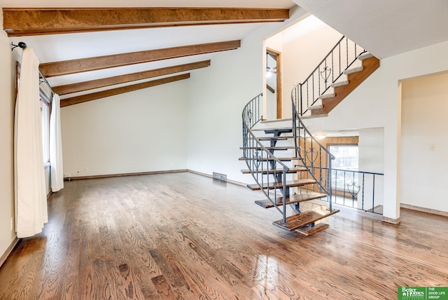 stairs with lofted ceiling with beams, wood finished floors, visible vents, and baseboards