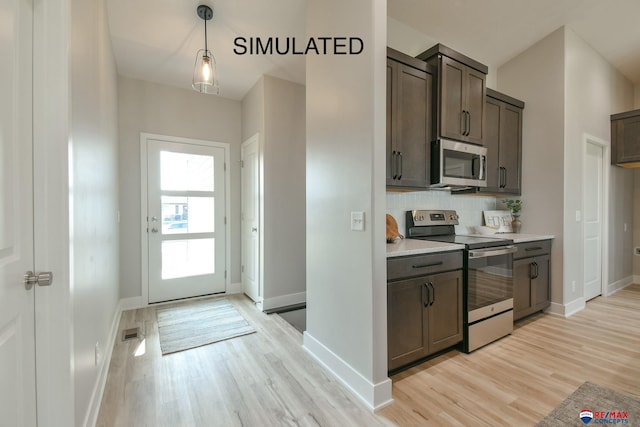 kitchen featuring stainless steel appliances, visible vents, light wood-style floors, light countertops, and tasteful backsplash