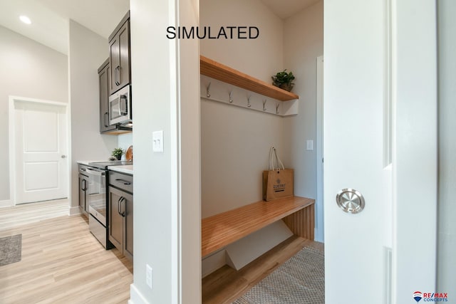 mudroom featuring baseboards, light wood-type flooring, and recessed lighting