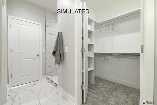 spacious closet featuring marble finish floor