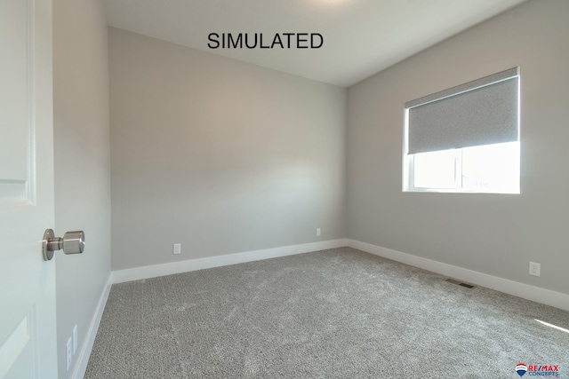 carpeted spare room with baseboards and visible vents