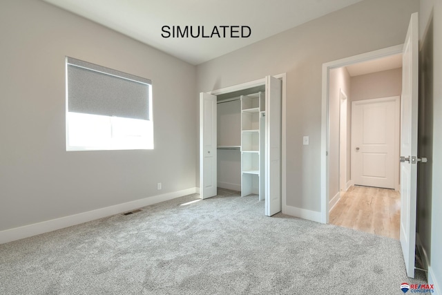 unfurnished bedroom featuring carpet floors, a closet, visible vents, and baseboards