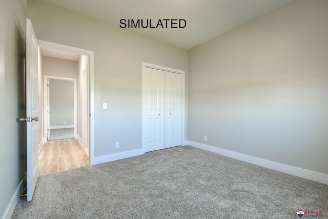 unfurnished bedroom with carpet floors, baseboards, and a closet