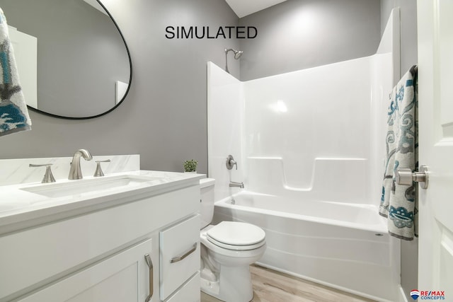 bathroom featuring toilet, wood finished floors, shower / tub combination, and vanity