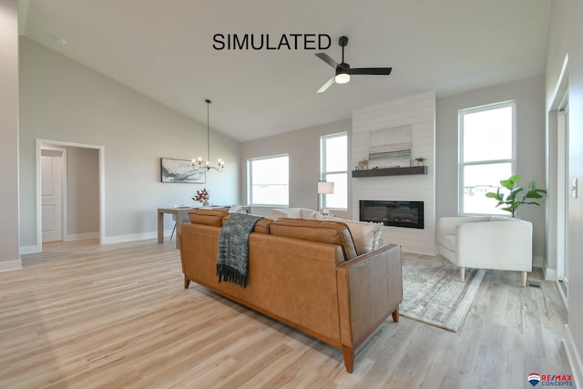 living room featuring high vaulted ceiling, ceiling fan with notable chandelier, a fireplace, baseboards, and light wood finished floors