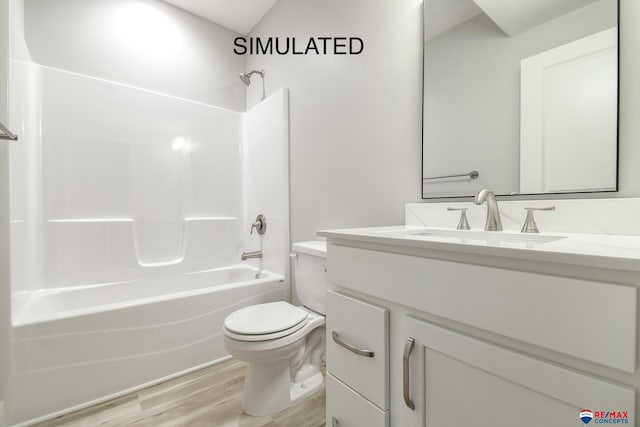 bathroom featuring toilet,  shower combination, wood finished floors, and vanity