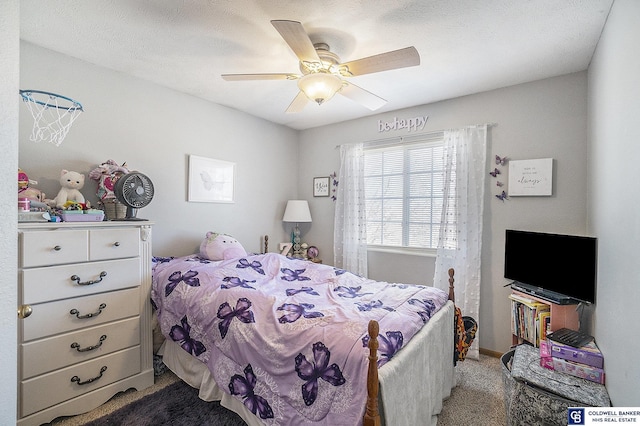 bedroom featuring dark colored carpet, a textured ceiling, and a ceiling fan