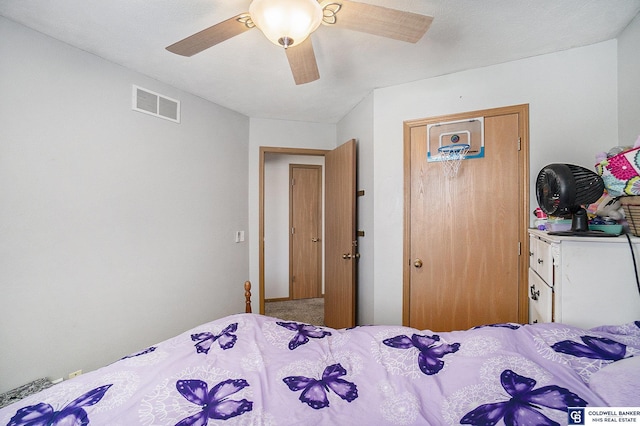 bedroom featuring visible vents, carpet flooring, and a ceiling fan