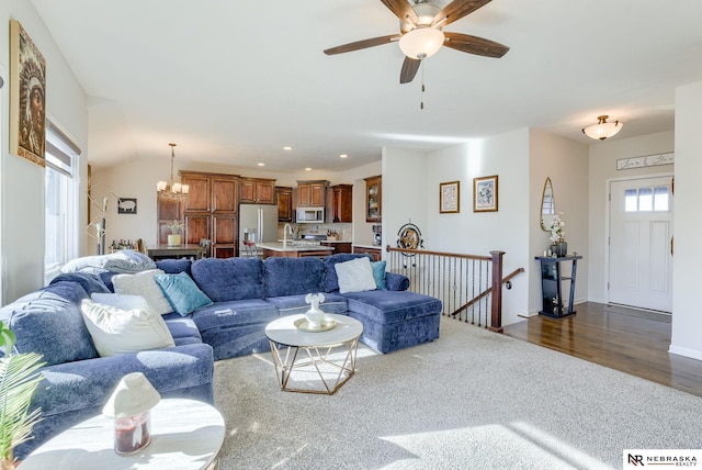 living area featuring recessed lighting, dark wood finished floors, plenty of natural light, and ceiling fan with notable chandelier