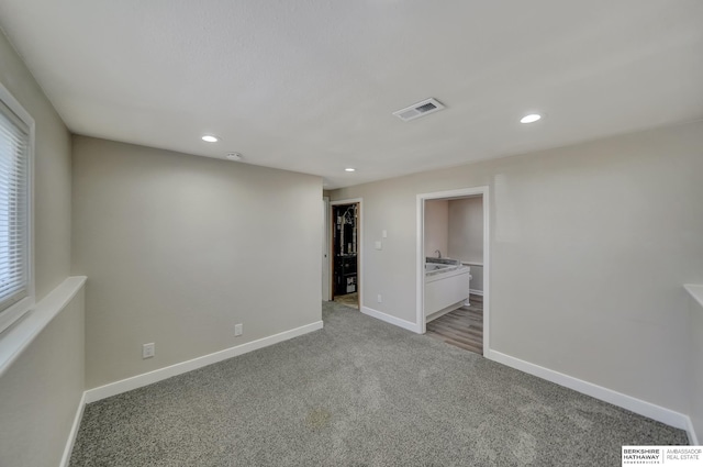 empty room with recessed lighting, visible vents, baseboards, and light colored carpet