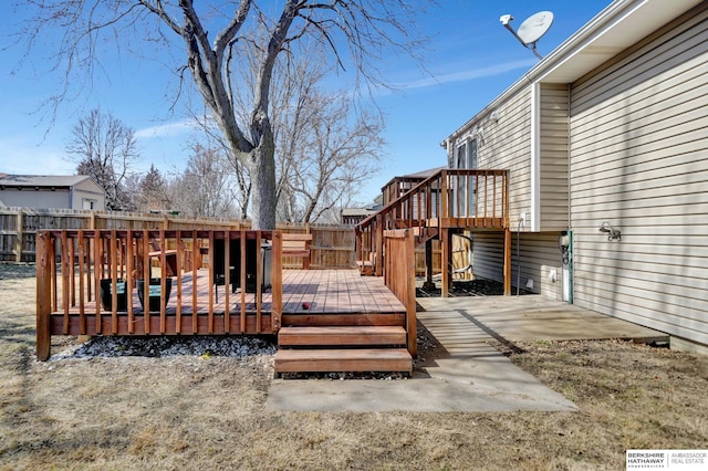 deck with a patio and a fenced backyard