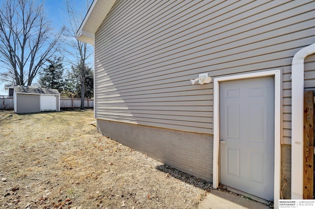 view of exterior entry featuring fence