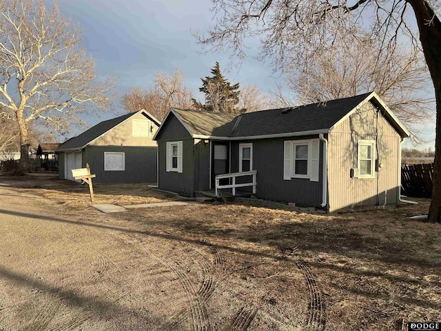 view of front facade with roof with shingles