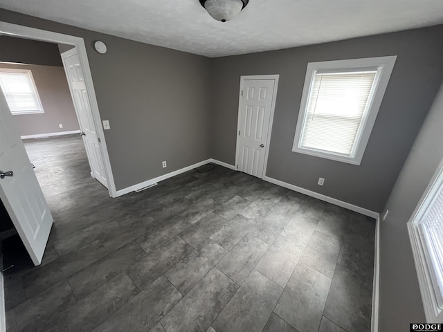 unfurnished bedroom featuring baseboards