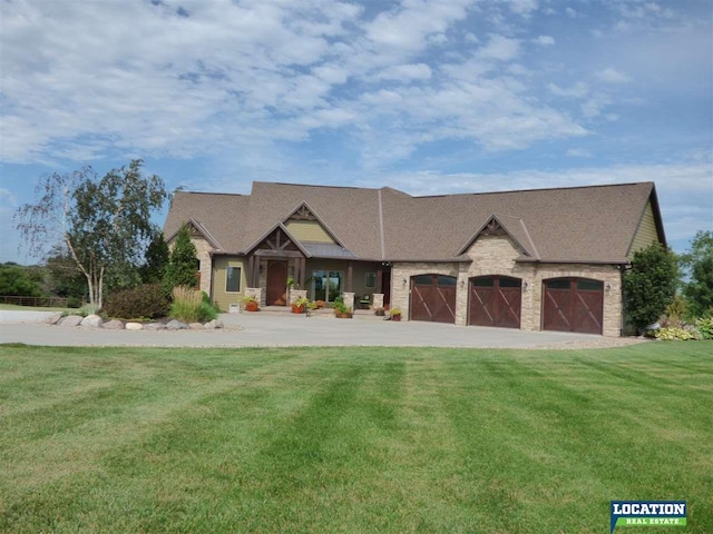 view of front of home with an outbuilding, a garage, a barn, concrete driveway, and a front lawn