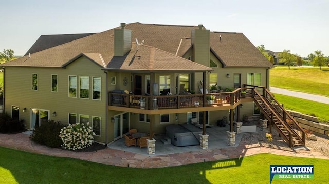 rear view of property with a chimney, stairs, a deck, a yard, and a patio area