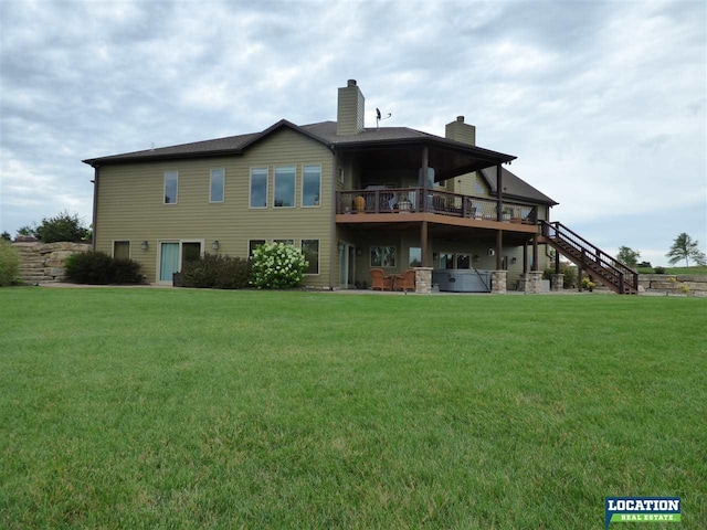 rear view of property with a deck, a yard, stairway, and a chimney