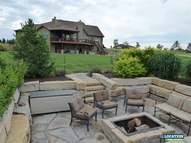 view of patio / terrace with a fire pit and stairs