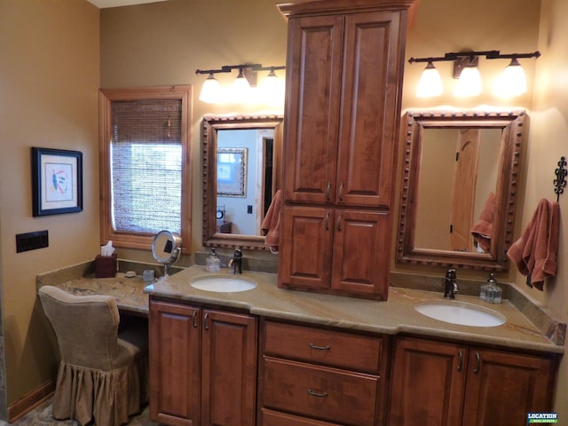 bathroom with a sink and double vanity