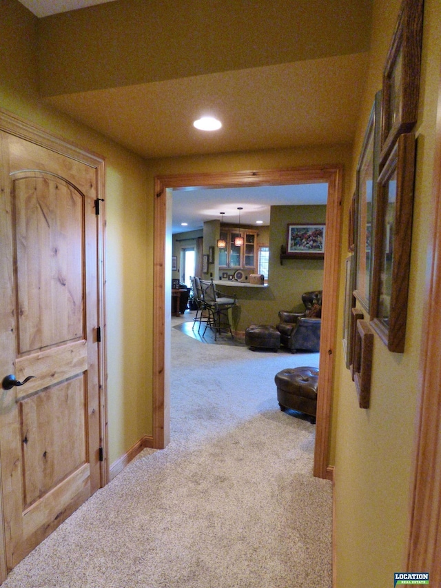 hallway with recessed lighting, carpet, and baseboards