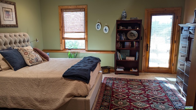 bedroom featuring access to outside and carpet flooring