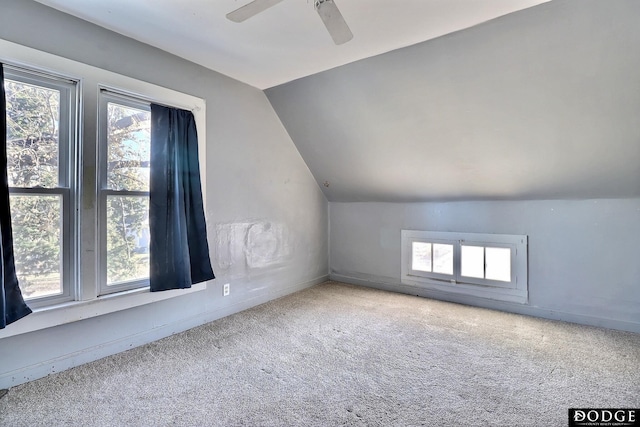 bonus room featuring lofted ceiling, carpet floors, a ceiling fan, and a healthy amount of sunlight