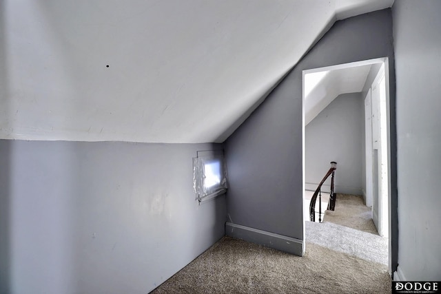 additional living space with carpet flooring and vaulted ceiling