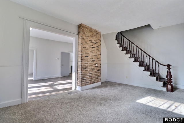 interior space with carpet, visible vents, and stairway