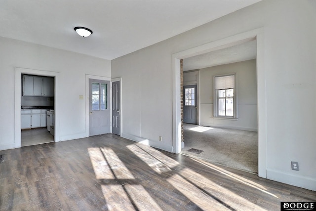 interior space with visible vents, baseboards, and wood finished floors