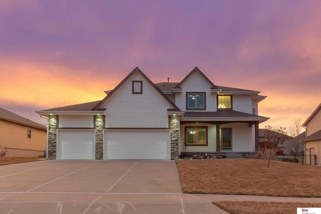 view of front of property featuring a garage, stone siding, covered porch, and concrete driveway